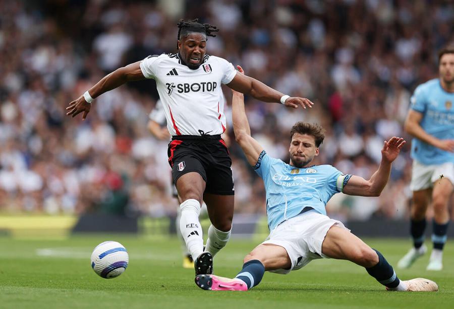  Adama Traore is tackled by Ruben Dias
