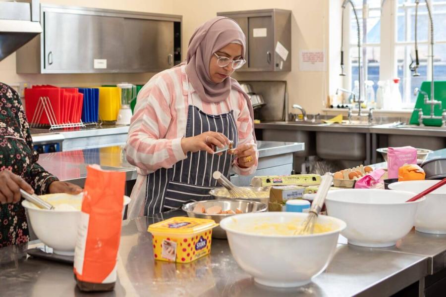 Students measuring ingredients in cooking course