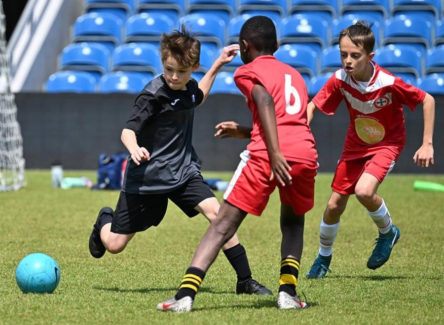 Semi-final between West London Free (in black) and Holy Cross (in red)