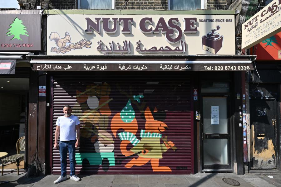 Khalil Chedid, owner of Nut Case, stands outside his newly painted shutter