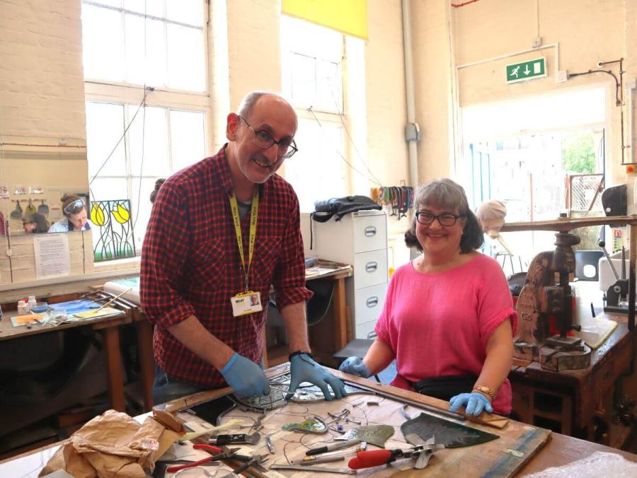 Stained glass tutor, Tim Cunliffe, teaching a student leading technique