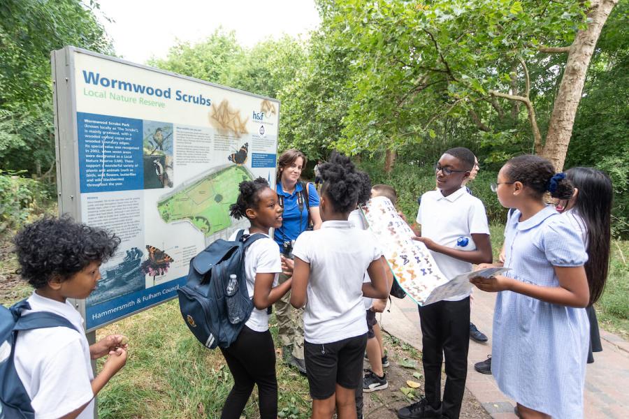 Old Oak primary school embark on a guided nature walk of Wormwood Scrubs meadow