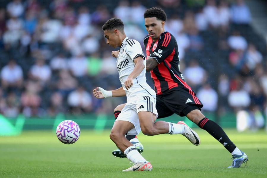 Joshua King is put under pressure by Nnamdi Collins