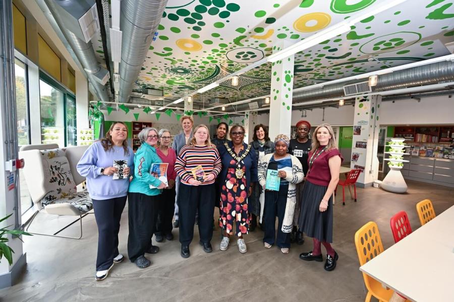 Keen readers at the Nourish Hub with H&F Mayor Cllr Sharon Holder (centre)