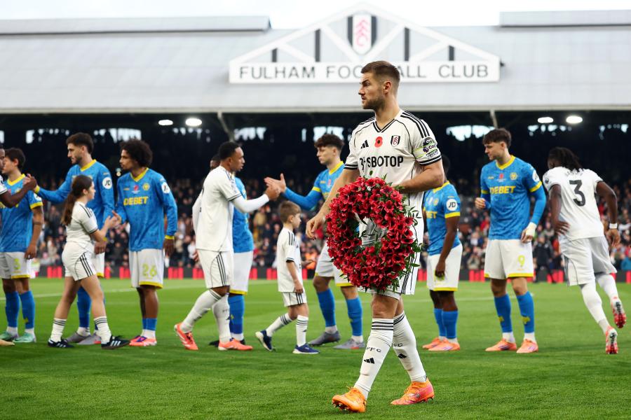 Joachim Andersen lays a poppy wreath before the game