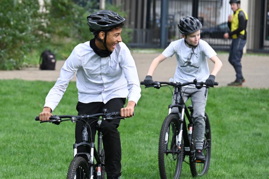 Secondary school pupils on their bikes in a local park in Hammersmith