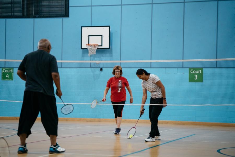 Older people playing badminton.