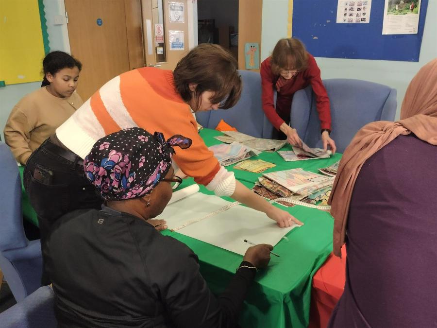 An instructor showing her trainees how to sew