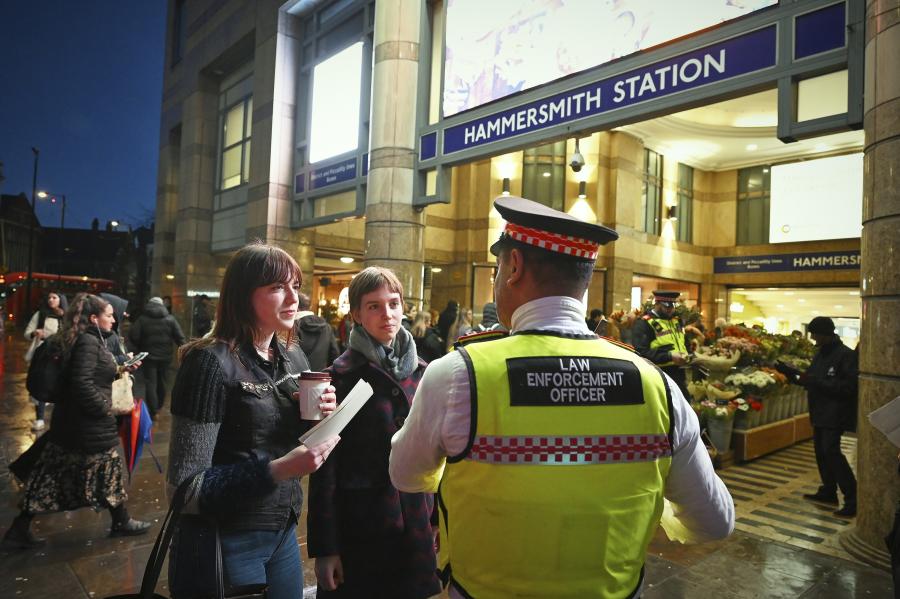 A LET officer engages with two residents outside Hammersmith Tube Station